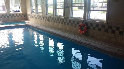a swimming pool with a red life preserver in a building at Americas Stay Inn-Leavenworth in Leavenworth