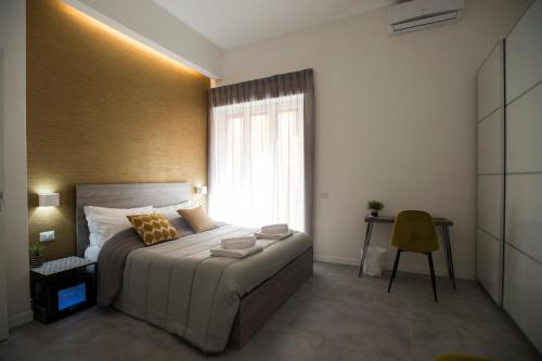 a bedroom with a large bed and a window at LECENTRE 174 in Salerno