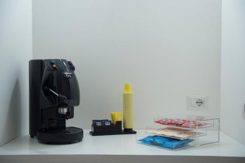 a black coffee maker sitting on a counter with a ruler at LECENTRE 174 in Salerno