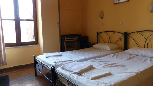 Katil atau katil-katil dalam bilik di Kydonia Rooms