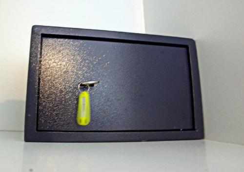 a small television with a yellow bottle on it at Korona Apartments in Vathi, Ithaka