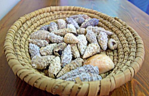 a basket of rocks sitting on a table at Korona Apartments in Vathi, Ithaka