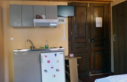 a small kitchen with a sink and a refrigerator at Kydonia Rooms in Chania