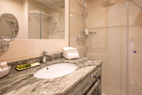 a bathroom with a sink and a shower at Los Geranios in Port de Soller