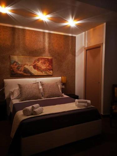 a bedroom with a bed with two towels on it at Beb oasi marina in Campofelice di Roccella