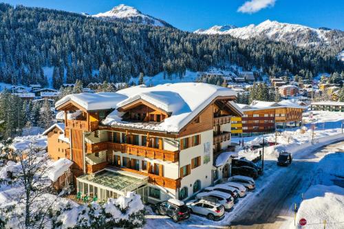 a hotel in the mountains with snow on the roof at Hotel Gianna in Madonna di Campiglio