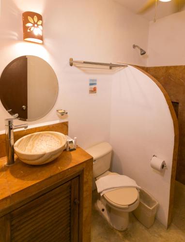 a bathroom with a sink and a toilet at Villas Margaritas Holbox in Holbox Island