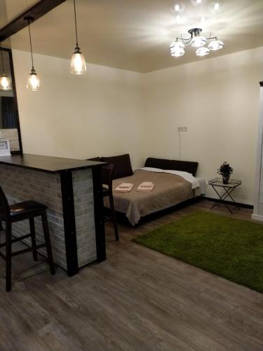 a bedroom with a bed and a desk and a table at АpartmentAnna in Odesa