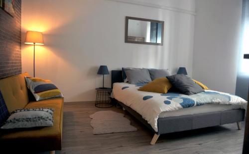 a bedroom with a bed and a couch at Rijeka center- Apartment Flumen in Rijeka