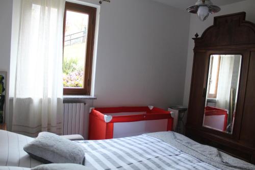 a bedroom with a bed and a window at A cà rèste in Capizzone