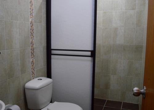 a bathroom with a toilet and a shower at Balcones de la Casona in Guatapé