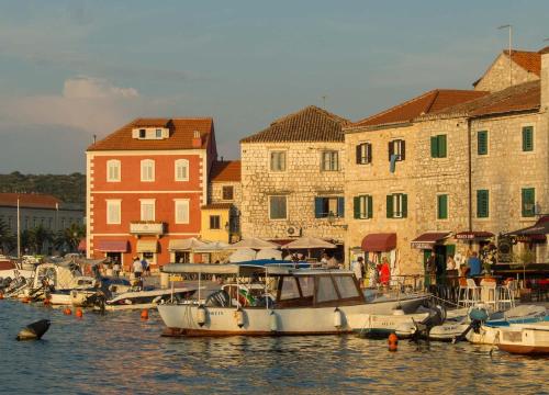 a group of boats docked in a harbor with buildings at House at the seafront in Stari Grad