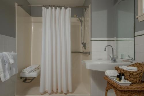 a bathroom with a shower curtain and a sink at Liberty Hill Inn in Yarmouth