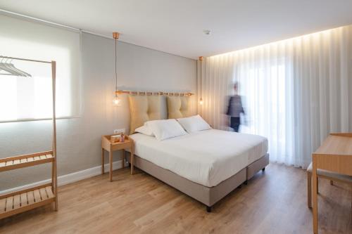 Ένα ή περισσότερα κρεβάτια σε δωμάτιο στο The Rex Hotel Porto