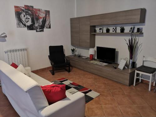 a living room with a white couch and a television at Chic 'N Charme Trastevere Terrace in Rome