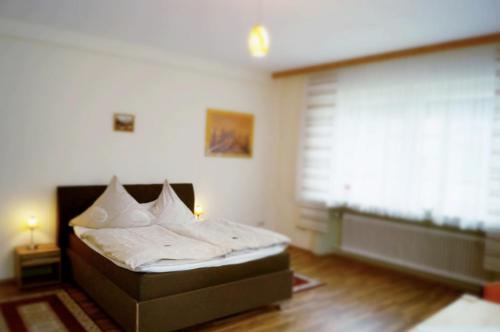 a bedroom with a bed and a large window at Hotel-Cafe Maxx in Lengerich