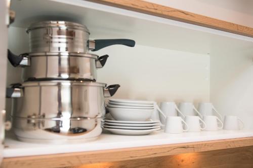a kitchen shelf with a coffee pot and dishes at Your Home - City Apartment in Kufstein in Kufstein