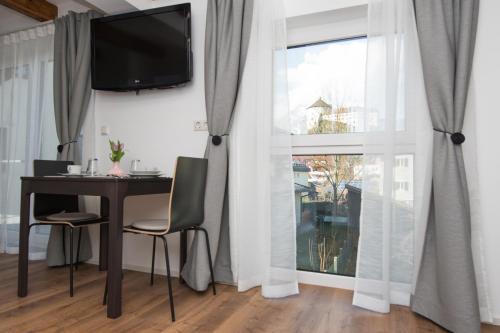a dining room with a table and a large window at Your Home - City Apartment in Kufstein in Kufstein