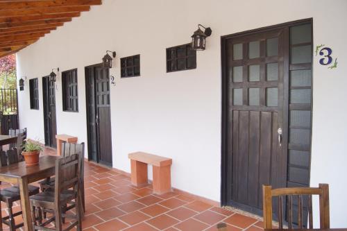 a room with a table and chairs and a door at Balcones de la Casona in Guatapé
