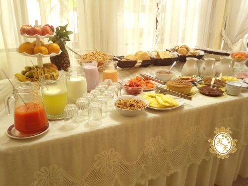 a table with a buffet of food and drinks at Hostal España in Sucre