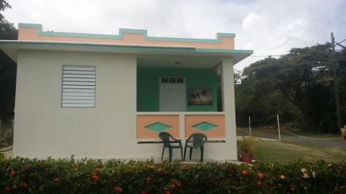 two chairs in front of a small house at Fajardo Peaceful Place in Playa Sardinera