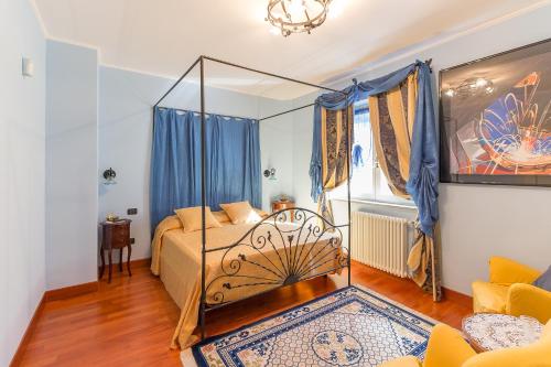 a bedroom with a bed with blue curtains at Tenuta Pian D'Attesio - Agriturismo in Castelletto Soprano