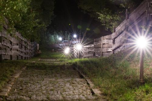 two street lights on a wall at night at Dworek Zyskowskiego in Danowskie