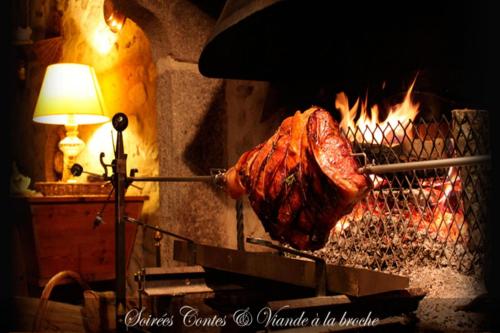 a piece of meat is being cooked in an oven at Le Relais du Vermont in Baffie