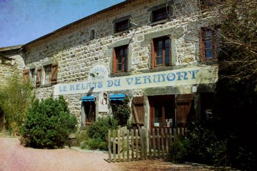 an old brick building with a sign on it at Le Relais du Vermont in Baffie