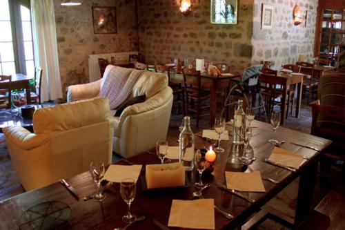 a dining room with a table and chairs and tables and tablesktop at Le Relais du Vermont in Baffie