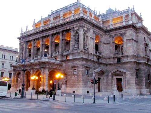 a large stone building on the corner of a street at Benczur Hotel in Budapest