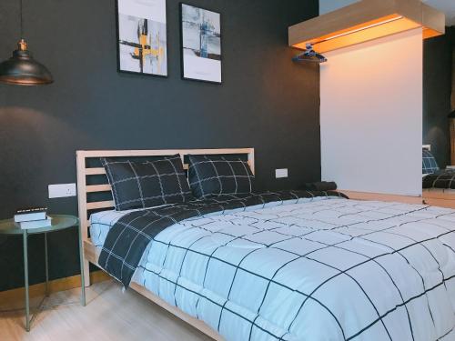 a bedroom with a large bed with a blue comforter at MykeyThe Wave A-17-13A Melaka City in Melaka