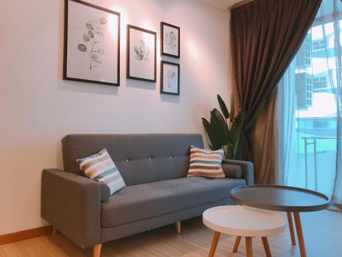 a living room with a couch and a table at MykeyThe Wave A-17-13A Melaka City in Melaka