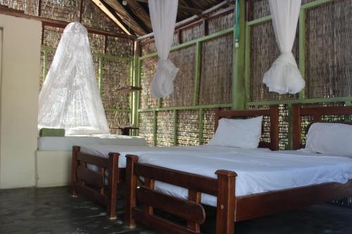 Postel nebo postele na pokoji v ubytování Eco Hotel Las Palmeras