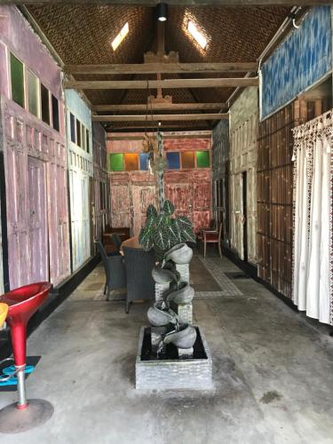 a room with a table and chairs in a building at Arjuna Garden Homestay in Yogyakarta