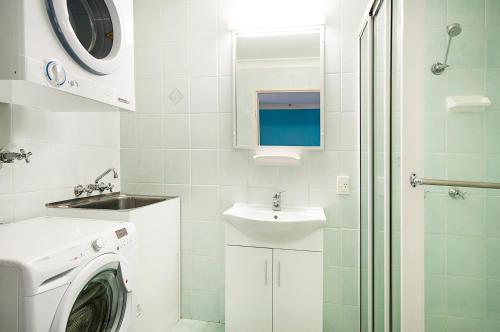 a bathroom with a sink and a toilet at Byron Bayside Central Studio Apartments in Byron Bay