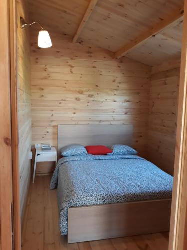 a bedroom with a bed in a wooden cabin at Cyprus Glamping Park in Ayios Theodhoros