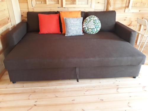 a brown couch with pillows on it in a room at Cyprus Glamping Park in Ayios Theodhoros