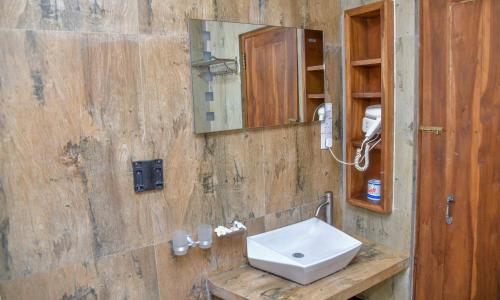 a bathroom with a sink and a mirror at Ceylon Sea Hotel in Tangalle
