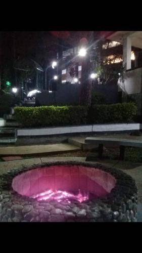 a fire pit in a park at night at M&M Residence in Baguio