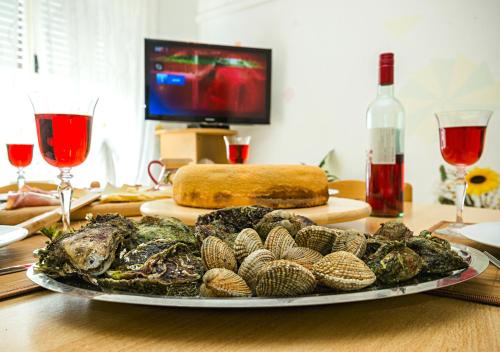 a plate of food with shells on a table at Apartment Dora in Umag