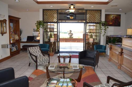 a lobby with chairs and tables and a large window at Ramada by Wyndham Arcata in Arcata