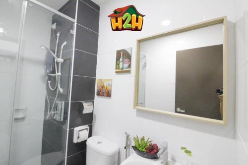 a bathroom with a shower and a mirror at H2H - TT Court Majestic Ipoh in Ipoh