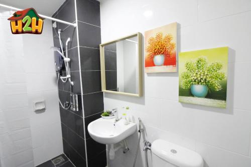 a bathroom with a sink and a mirror at H2H - TT Court Majestic Ipoh in Ipoh