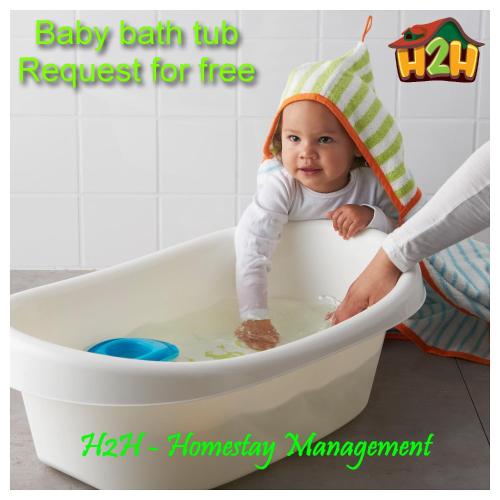 a baby sitting in a bath tub with a towel on its head at H2H - TT Court Majestic Ipoh in Ipoh