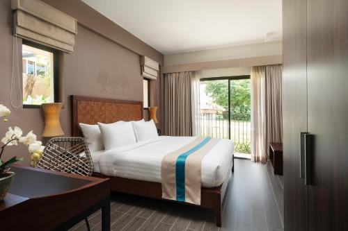 Postel nebo postele na pokoji v ubytování Bacau Bay Resort Coron