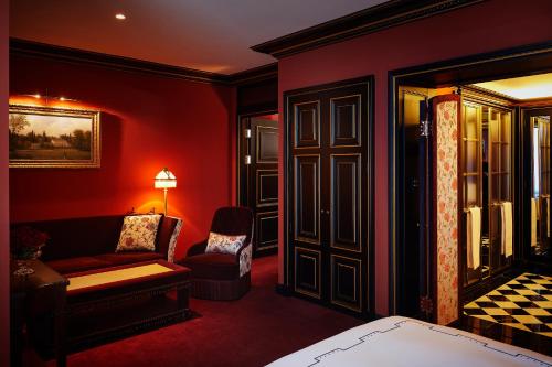 a red room with a couch and a chair at L'Escape Hotel in Seoul