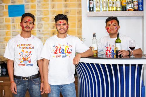 a group of three men standing at a bar at Beautiful Kathmandu Hotel in Kathmandu