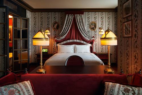 a bedroom with a bed with two lamps and a couch at L'Escape Hotel in Seoul
