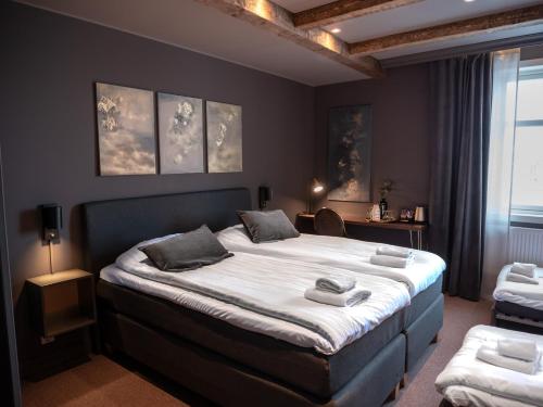 a bedroom with a large bed with two pillows on it at Hotell Gamla Staden in Kalix